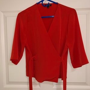 Coral colored wrap blouse